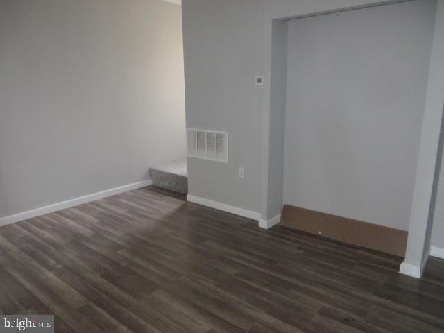 spare room with dark hardwood / wood-style flooring