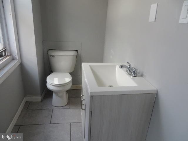 bathroom featuring vanity, toilet, and tile patterned flooring