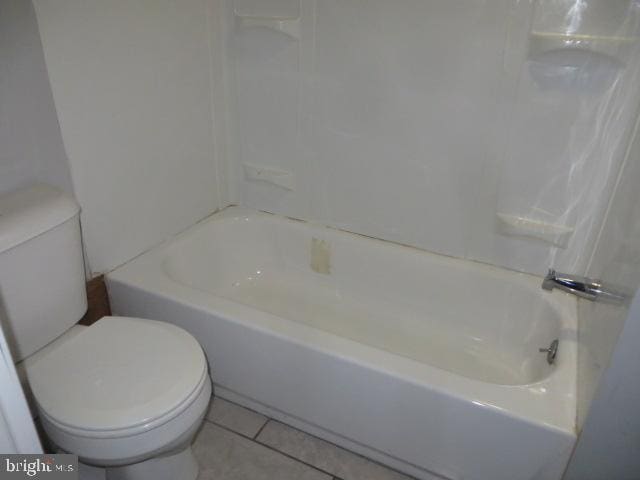 bathroom with tile patterned flooring, toilet, and shower / bath combination