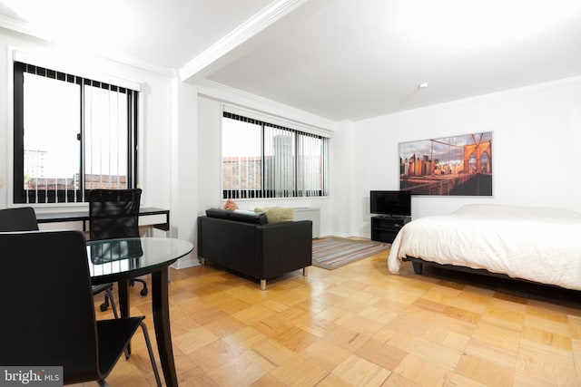 bedroom with crown molding and light parquet flooring