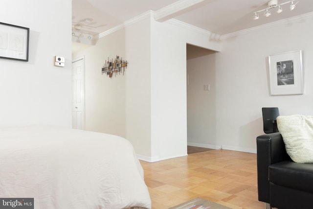 bedroom featuring track lighting and ornamental molding