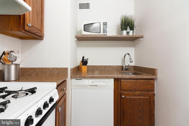 kitchen featuring extractor fan, sink, and white appliances