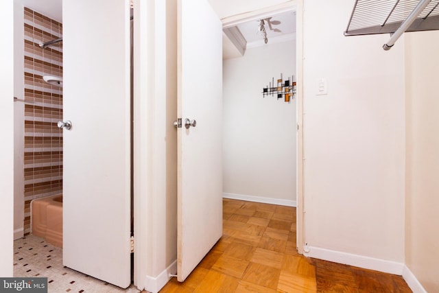 hall with crown molding and light parquet floors