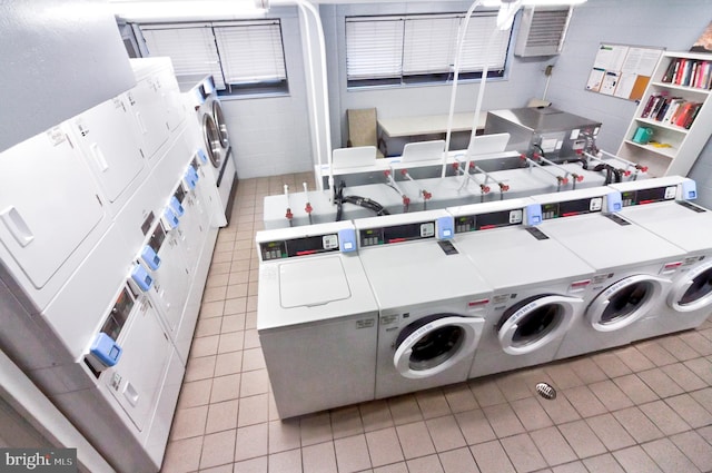 washroom featuring stacked washer and dryer, separate washer and dryer, and light tile patterned floors