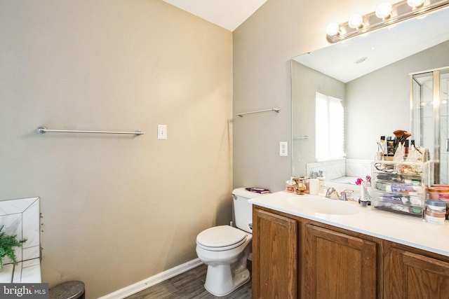 bathroom with vanity, vaulted ceiling, wood-type flooring, and toilet