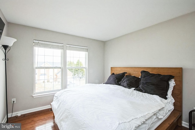 bedroom with dark hardwood / wood-style floors