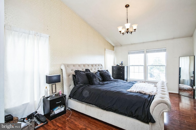 bedroom featuring vaulted ceiling, dark wood-type flooring, and a chandelier