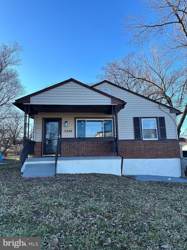 view of front of house featuring a front yard and covered porch