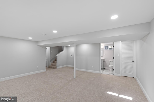 basement featuring light colored carpet