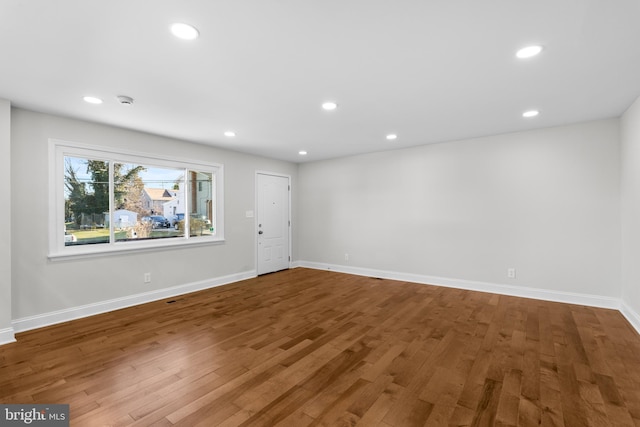 empty room with hardwood / wood-style floors