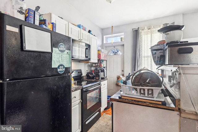 kitchen featuring white cabinetry and black appliances