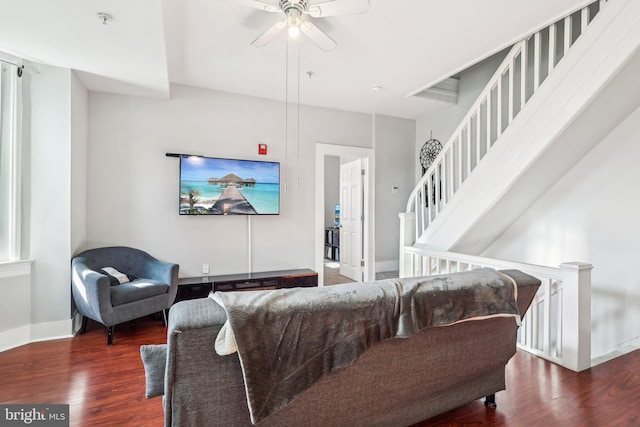 living room with ceiling fan and dark hardwood / wood-style floors