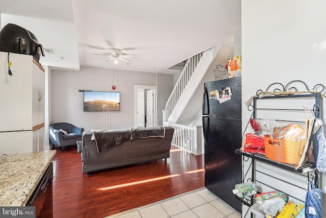 living room with ceiling fan and light hardwood / wood-style flooring