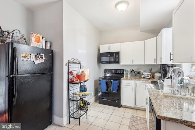 kitchen with white cabinetry, sink, light stone counters, and black appliances