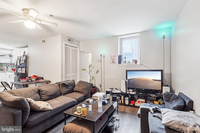 living room with wood-type flooring and ceiling fan