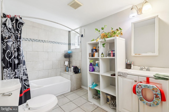 full bathroom featuring vanity, tile patterned floors, toilet, and shower / bath combo with shower curtain