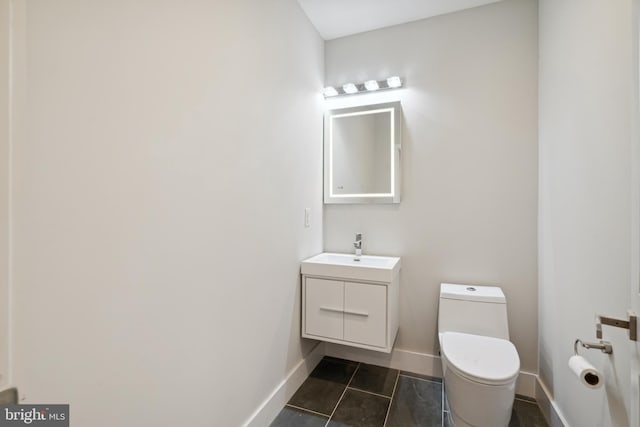 bathroom featuring vanity, toilet, and tile patterned flooring