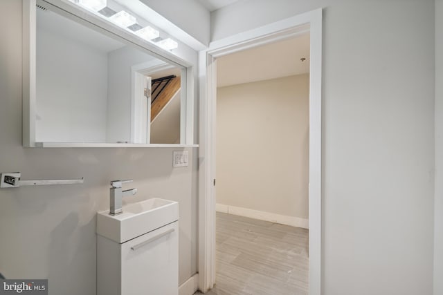 bathroom with vanity and wood-type flooring