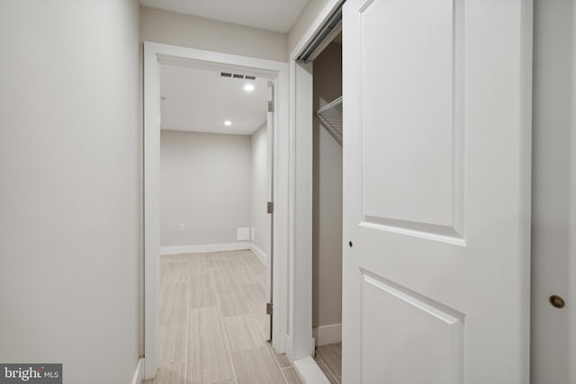 hallway with light hardwood / wood-style floors