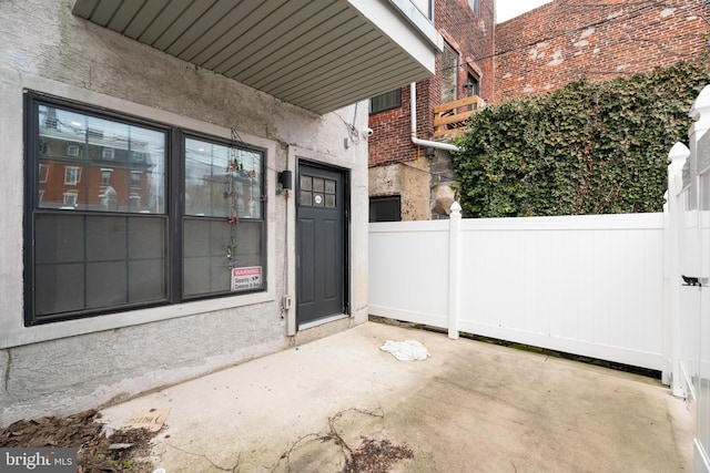 view of exterior entry with a patio area