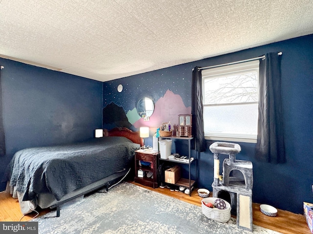 bedroom with wood-type flooring and a textured ceiling