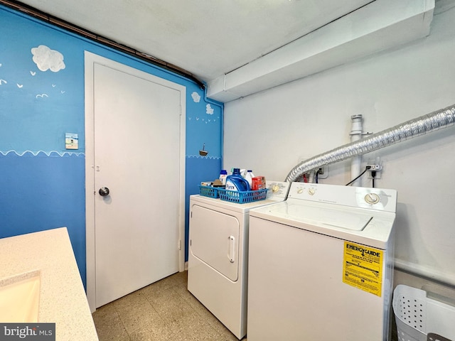 clothes washing area featuring separate washer and dryer