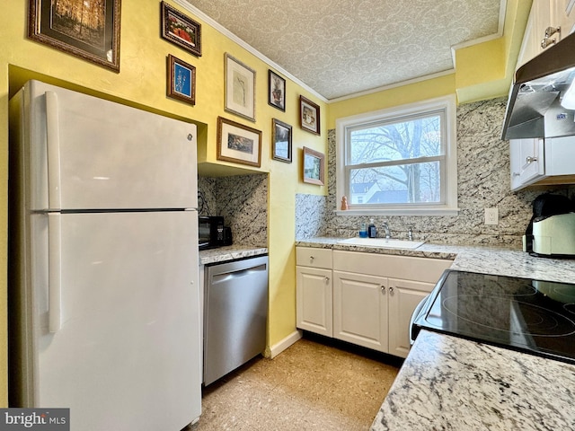 kitchen with sink, white cabinets, white refrigerator, stainless steel dishwasher, and crown molding