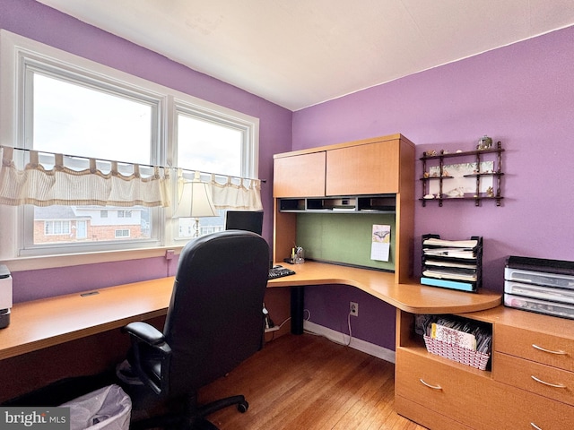 office space featuring light hardwood / wood-style flooring and built in desk