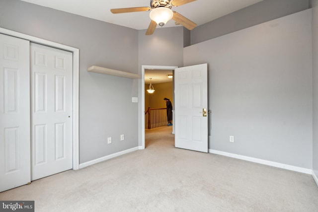 unfurnished bedroom with carpet, baseboards, and a closet