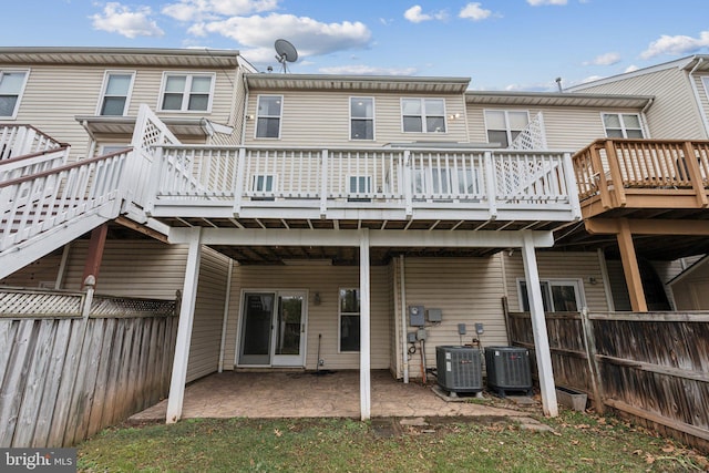 back of house featuring a patio area, fence, cooling unit, and a wooden deck