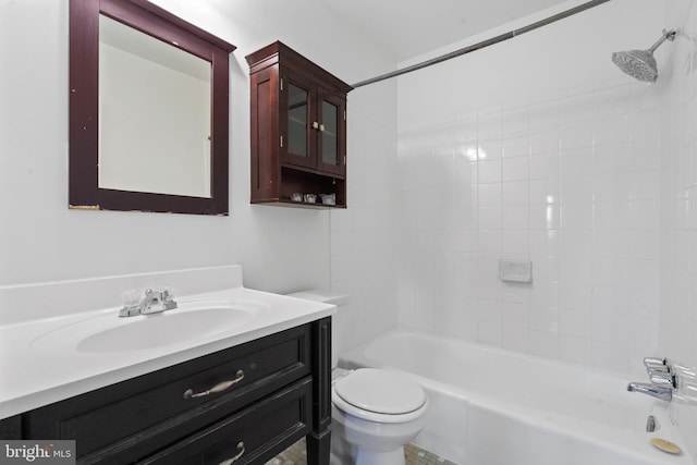 full bathroom featuring vanity, tiled shower / bath combo, and toilet