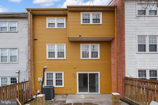 rear view of house featuring central AC