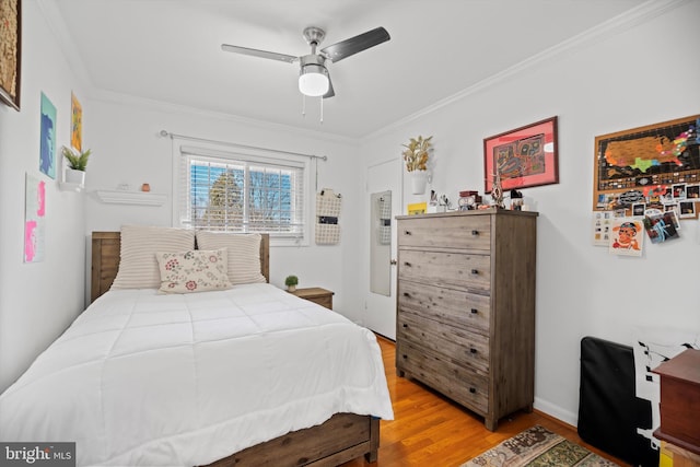 bedroom featuring crown molding, ceiling fan, and hardwood / wood-style flooring