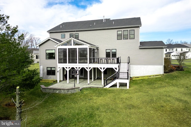 back of house with a yard, a deck, a patio area, and a sunroom