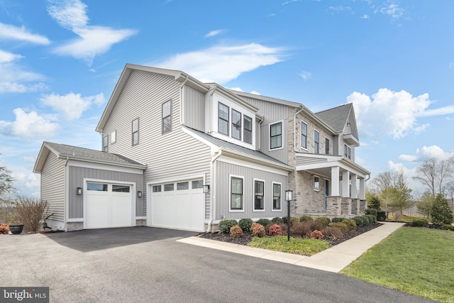 view of front of property with a garage and a front lawn