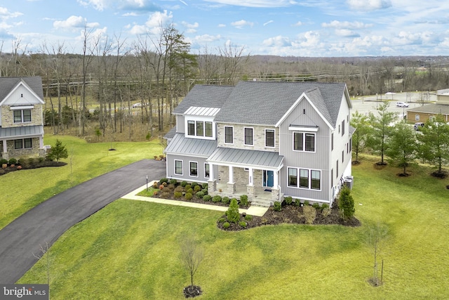 view of front facade featuring a front yard and covered porch