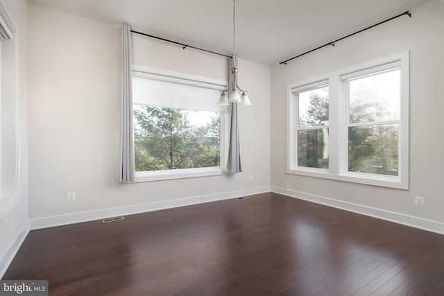 unfurnished room with dark wood-type flooring