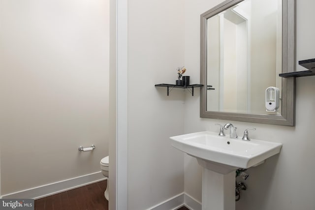 bathroom with wood-type flooring and toilet