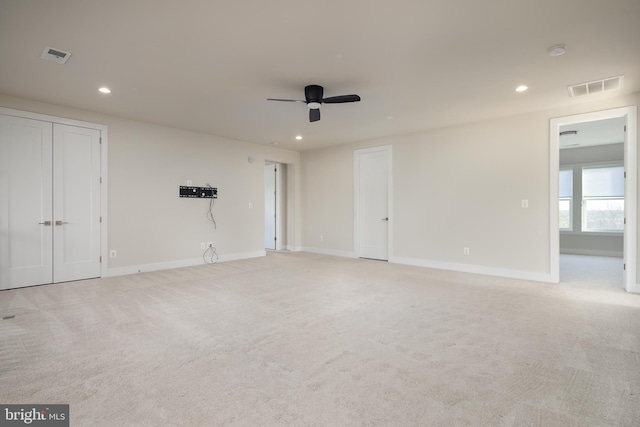 carpeted empty room featuring ceiling fan