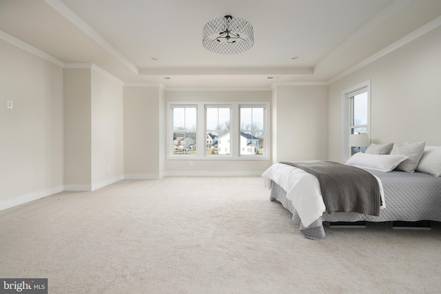 bedroom featuring crown molding, a raised ceiling, and carpet