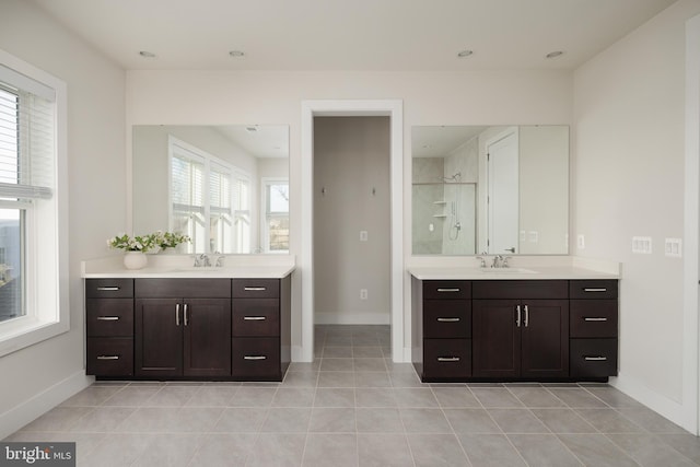 bathroom featuring tile patterned flooring, vanity, and tiled shower