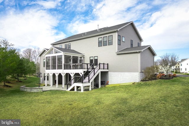 rear view of house with a yard, a deck, a patio area, and a sunroom