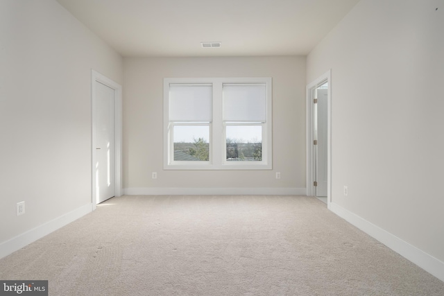 empty room featuring light colored carpet