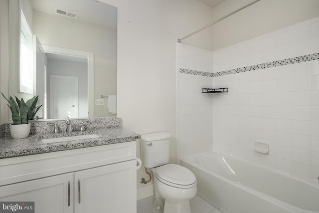 full bathroom featuring vanity, toilet, and tiled shower / bath combo