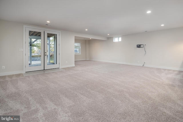 unfurnished room featuring light carpet and french doors