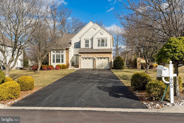 view of property with a garage and a front yard