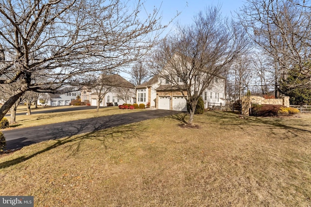 view of front of property featuring a garage and a front yard