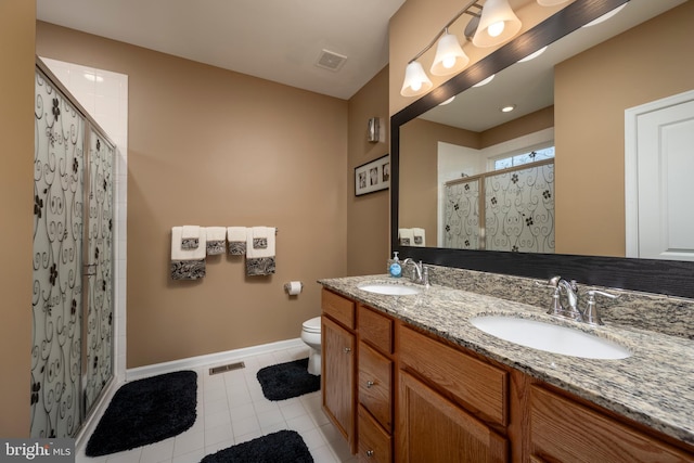 bathroom featuring vanity, tile patterned floors, a shower with door, and toilet