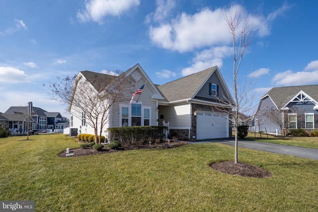 view of front of home with a garage and a front yard