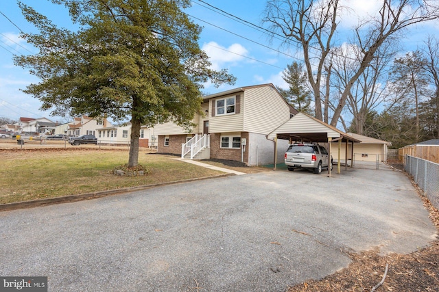 raised ranch with a front yard and a carport